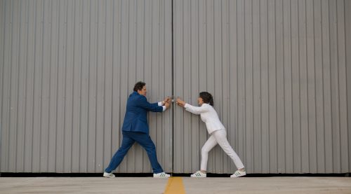 2 people pulling warehouse doors open | Can Website Colors Boost Profits and Success? | Brighter Vision Web Solutions | Therapist Websites & Marketing for Therapists | Blog for Therapists
