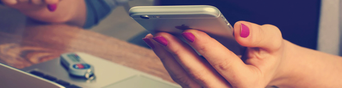 Female hand holding silver iphone | 7 Creative Ways to Reach Local Clients | Brighter Vision | Therapist Websites & Marketing for Therapists | Blog for Therapists
