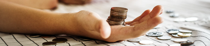 Child's hand holding stack of coins | How to Find Out if Your Private Practice Online Marketing is Actually Working | Brighter Vision Web Solutions | Marketing Blog for Therapists