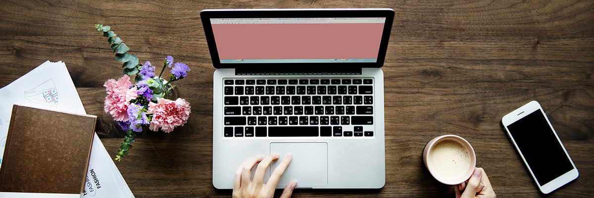 MacBook, wood desk, flowers | How to Write the Best Content for Your Private Practice Website | Brighter Vision Web Solutions | Marketing Blog for Therapists