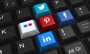 Social sharing buttons on black keyboard | 7 Tips to Build an Enthusiastic Following For Your Facebook Business Page | Brighter Vision | Marketing Blog for Therapists