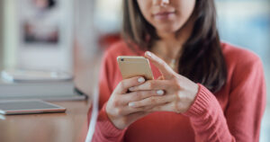 Close up of woman texting on phone