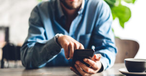 Man using smartphone to access website