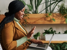 Therapist on laptop talking to patient