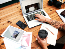 person working on laptop and tablet on a table